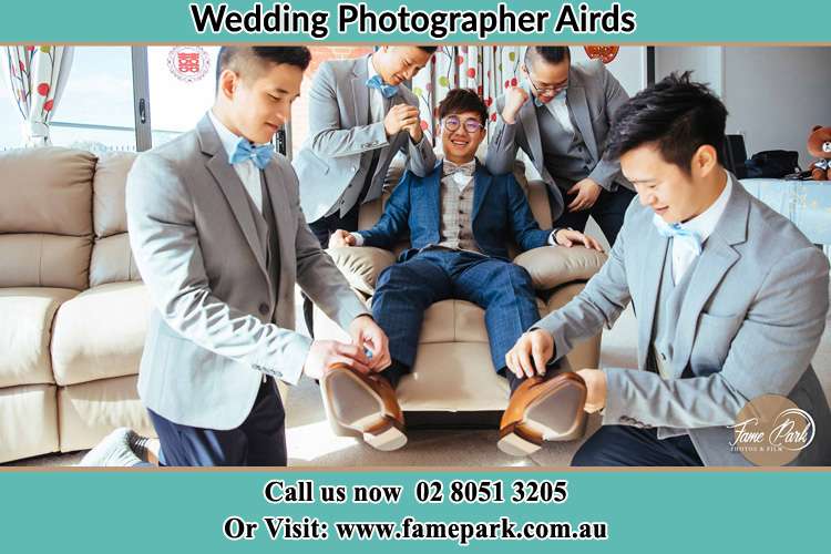 Photo of the Groom helping by the groomsmen getting ready Airds NSW 2560