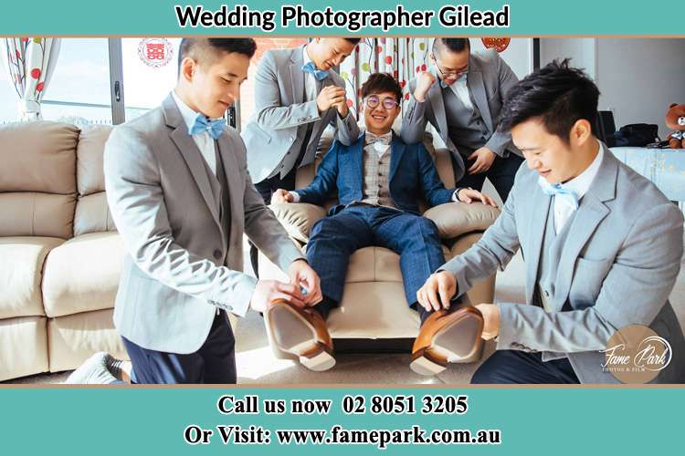 Photo of the Groom helping by the groomsmen getting ready Gilead NSW 2560