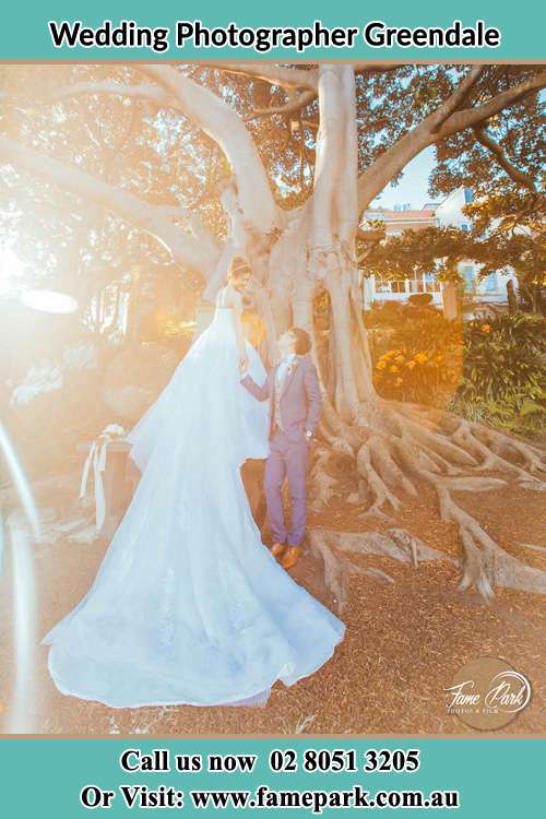 Photo of the Bride and the Groom looking each other besides the tree Greendale NSW 2745