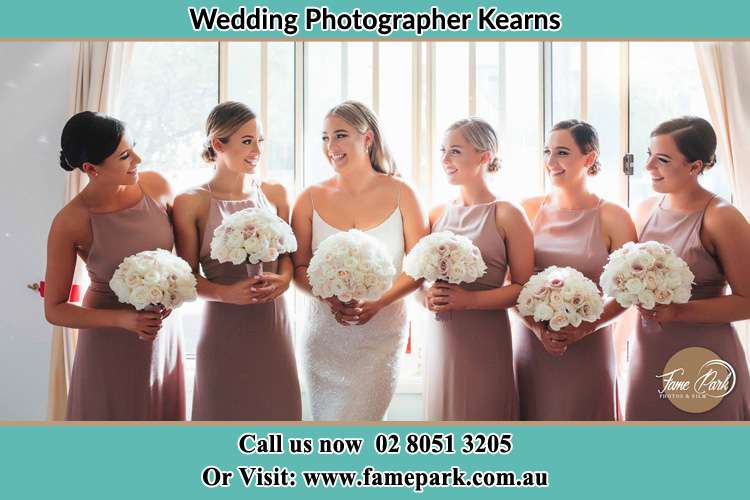 Photo of the Bride and the bridesmaids holding flower bouquet Kearns NSW 2558