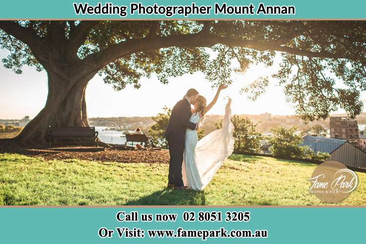 Photo of the Bride and the Groom kissing under the tree Mount Annan NSW 2567