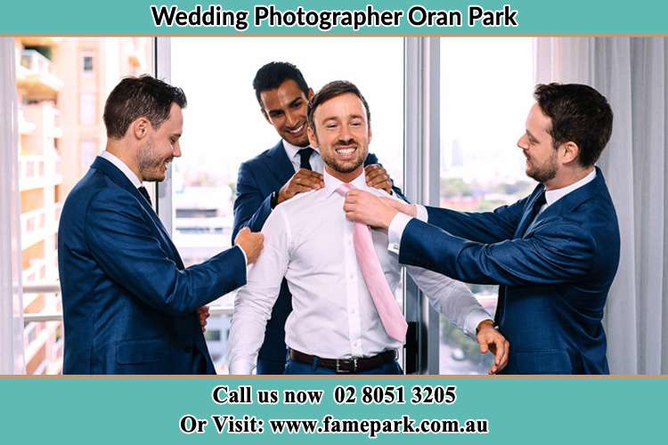 Photo of the Groom helping by the groomsmen getting ready Oran Park NSW 2570