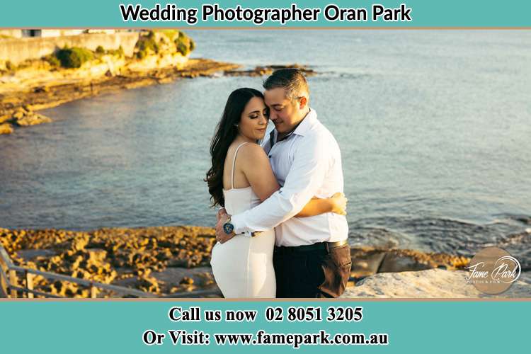 Photo of the Bride and the Groom hugging near the lake Oran Park NSW 2570