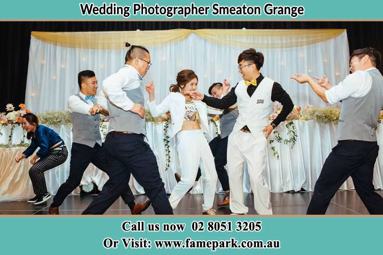 Photo of the Groom and the Bride dancing with the groomsmen on the dance floor Smeaton Grange NSW 2567