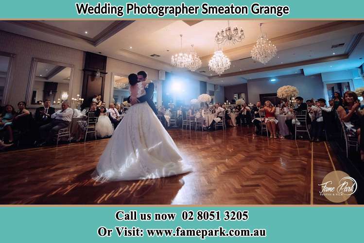 Photo of the Bride and the Groom hugging on the dance floor Smeaton Grange NSW 2567