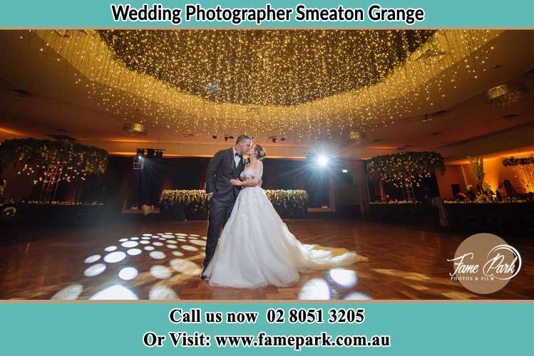 Photo of the Groom and the Bride kissing on the dance floor Smeaton Grange NSW 2567