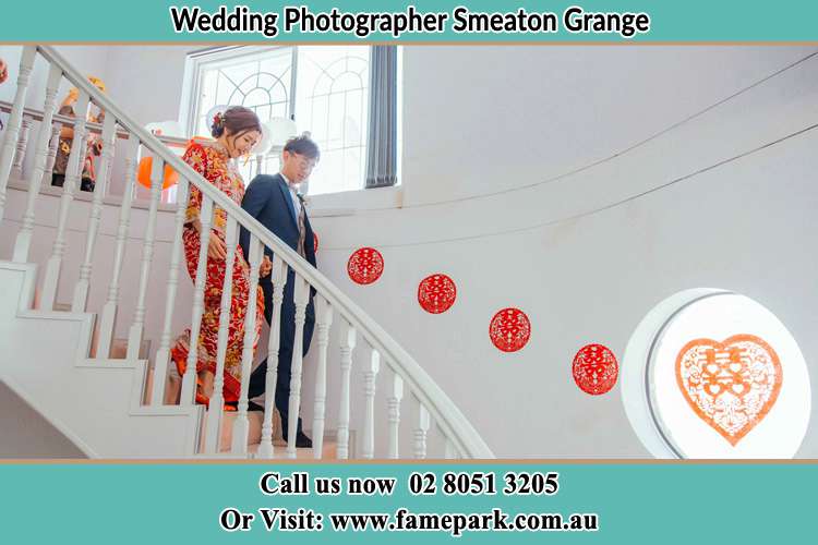 Photo of the Bride and the Groom going down the stair Smeaton Grange NSW 2567